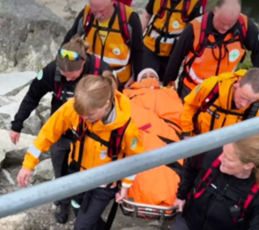 Norwegian People's Aid volunteers carrying an injured hiker to safety